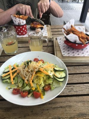Salad with vegan cheese, sweet potato fries and burger  at Pivnica Union in Ljubljana