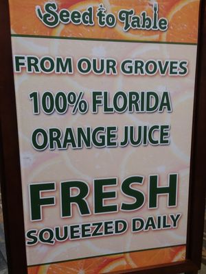 Sign about orange juice at Seed to Table Market in Naples