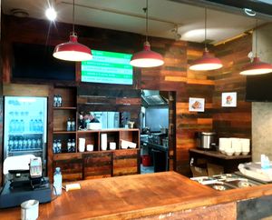 Serving counter with displayed menu.  at Vegan Om in Bratislava