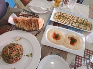 tabule salad (left) hummus and baba ghanoush covered in tahini (top) at Pita  in Merida
