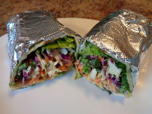 Spicy Thai Salad ordered as a wrap. Romaine lettuce, Asian cabbage, carrots, rice noodles, slivered almonds, sesame seeds, edamame, scallions, spicy cashew vinaigrette.  at CLE - Currito - Main Terminal in Cleveland