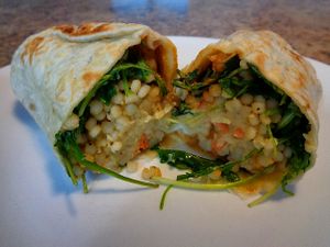 Harissa Wrap. New item, looked vegan minus the feta but not marked. Lemon couscous, arugula, carrots, hummus, spicy harissa vinaigrette, golden raisins, sumac spice  at CLE - Currito - Main Terminal in Cleveland