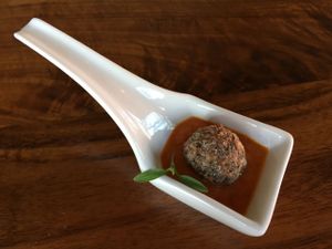 Amuse Bouche - Forbidden rice Swedish style meatball with micro cilantro in marinara. at Encuentro in Oakland