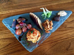 Sharp cashew cheese plate with fig chutney, grain mustard, walnut 'honey', seasonal fruit. at Encuentro in Oakland