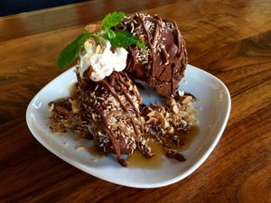 Joyful almond ice cream sandwich - chocolate chocolate chip cookie with coconut ice cream. at Encuentro in Oakland