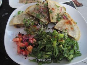 Quesadilla with cashew pecan chipotle cheese with seasonal vegetables, guacamole, salsa and cilantro lime cream at Encuentro in Oakland