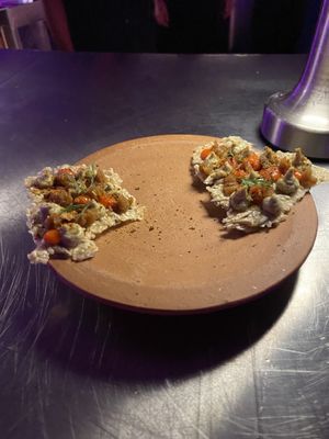 Seeded crackers with nacho type veg on top  at Tanaman in Seminyak