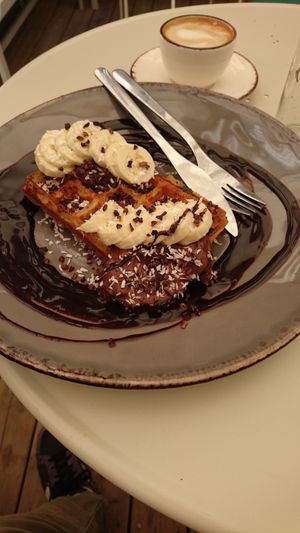 Belgian Waffles - chocolate/banana, alongside a cappuccino at Farm2Table - Davidshall in Malmo