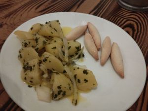 Papas aliñas, cooked potatoes with raw onion and herbs. We enjoyed every bite of it! at Kerkus Veggie Bar in Montecorto