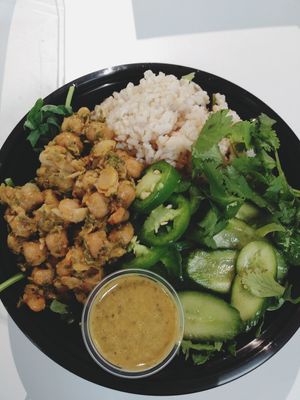 Create your own salad jerk chickpeas. Brown rice Jalapeno cilantro cucumbers house-made cilantro dressing at Infusedlife Plant Based Emporium in Minneapolis
