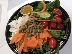 Create your own salad. This one has daikon cucumbers carrots. Pepitas tomatoes mixed greens house-made cilantro vinaigrette at Infusedlife Plant Based Emporium in Minneapolis