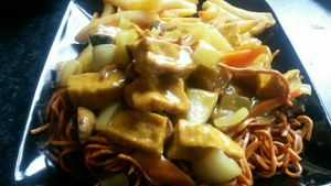 Tofu curry with vegan noodles and chips at Yummy Cottage in Newcastle Upon Tyne