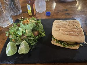 Black bean burger with salad instead of fries at Cafe Europa in Liberia