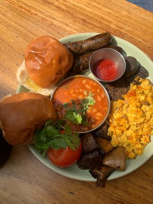 Vegan breakfast called the vegan Bombay- includes masala beans, tofu scramble, mushroom sausages, vegan black pudding, mushrooms, tomato and a bun at Dishoom in East London