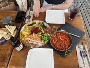 Menemen with tofu w/ fried bread (right and left), walnut pesto toast breakfast (comes w/ hummus, vegetables, olives, potato fries), a kombucha and iced purple basil tea  at Terradan Pub in Ankara