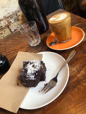 Vegan chocolate brownie and a beautiful almond latte. Such a peaceful atmosphere in this little hidden gem :) at Monk Bodhi Dharma in Balaclava