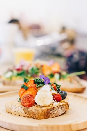 Peanut butter toast with strawberries & berries, mint and roasted hazelnuts.
 at Le Mango Tree 2 in Hossegor