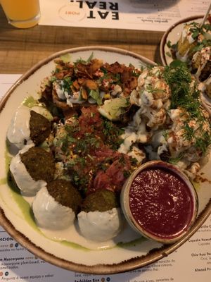 Home made falafel with beet ketchup, grilled tahini harissa cauliflower, Latin lover salad  at Honest Greens in Lisbon