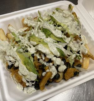 Cali loaded fries - cheesy soy curls, black beans, avocado, lettuce & ranch on fries at Nom Eats with Seats in Reno