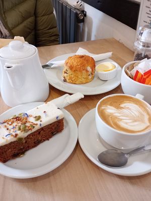 Pot of Earl Grey tea, flat white, carrot cake, scone with vegan butter. All very very good 😋 at Leaf & Bean in Broadway