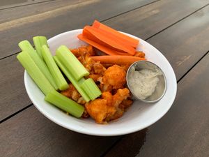 Fried cauliflower tossed in buffalo sauce, served with celery, carrots, and vegan ranch
 at Chestnut Hill Brewing Company in Philadelphia