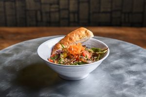 Firepit Salad: Arugula, spinach, roasted corn, roasted red pepper, pickled red onion, avocado, sunflower seeds, vegan feta, spicy smoked chili vinaigrette at Chestnut Hill Brewing Company in Philadelphia