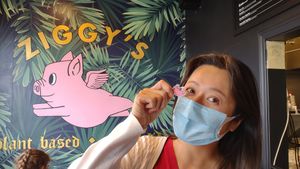 Happy customer with flying pigs at Ziggy's in San Luis Obispo