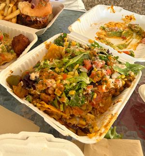 Worst nachos I’ve ever had. Watery bland cheese. In seasoned pinto beans. Unpleasant chunks of sausage. Not enough salsa or guacamole  at Oh My Soul in Charlotte