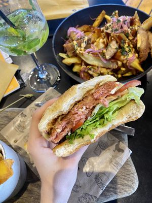 “Amazing vegan burger” & “Devil’s soy” loaded fries 😋  at Pisek Bar in Celje