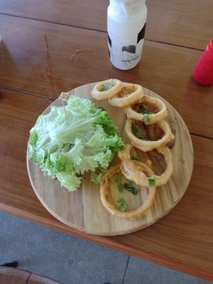 Protein burger wrapped in lettuce and onion rings at Herbivoro in Cancun
