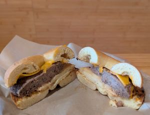 sourdough bagel with vegan cheese, sausage, and egg at Seize the Bagel in Vancouver