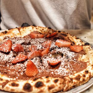 Vegan chocolate dessert pizza with fresh strawberries & powder  at Oregano in Brooklyn
