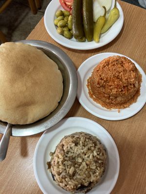 Pitas, tomato burgul, magadra (rice and lentils mix), pickles (go with hummus)  at Abu Shaker in Haifa