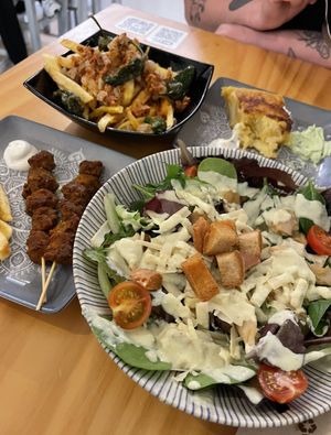 Patatas gordiveganas, tortilla de patatas, pinchito moruno and ensalada de cesar at La Vegana Taperia in Malaga