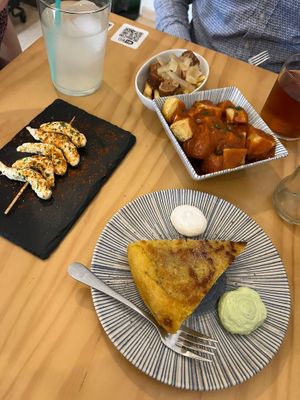 Gambas, tortillas Patatas, Patatas bravas and chorizo with fries at La Vegana Taperia in Malaga