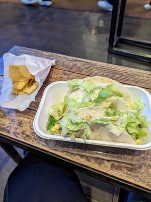 Three tacos with potatoes, pinto beans, green Chile, Chile corn, guacamole, and lettuce. at Illegal Pete's in Tucson