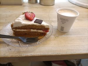 Vegan cake with cream and strawberries and coffee with soy milk at Liberty in Trieste