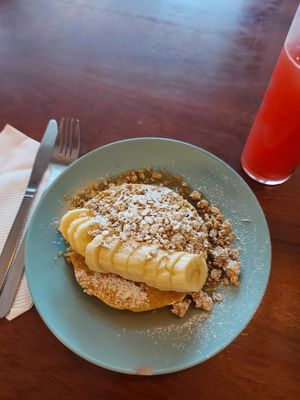 Vegan pancakes stack with banana, granola and maple syrup at O Diplomata in Porto