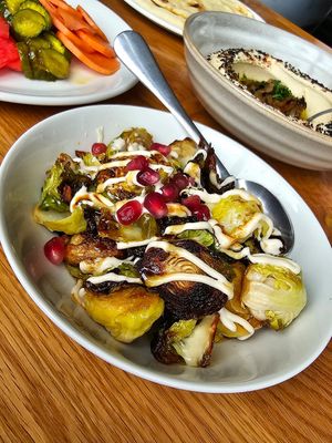 close up of the crispy brussels sprouts (cashew puree & pomegranate) at Zhug in Cleveland Heights