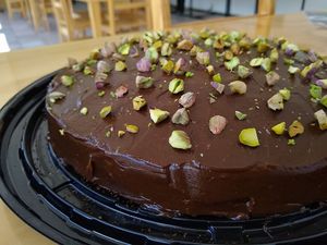 Cocoa cake with avocado bitumen and pistachio chips. at Kammi in Matamoros