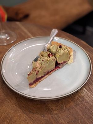 Raspberry tart with pistachio cream at Szklarnia in Krakow