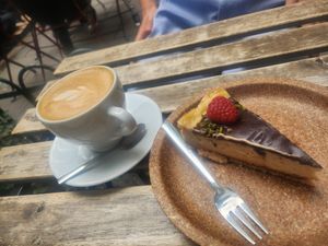Flat white and raspberry cheesecake at Szklarnia in Krakow