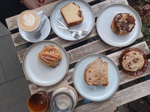 Cappuccino, orange cake, vanilla pudding bun, cardamom bun, pumpkin-tofu sandwiche, chocolate chip cookie, chai latte at Szklarnia in Krakow