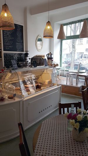 Interior of location - seating space and view towards the counter at Cafe Katulki in Berlin