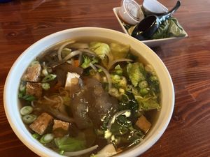 vegan pho with garnish on the sidee  at MOE PHO in Pendleton