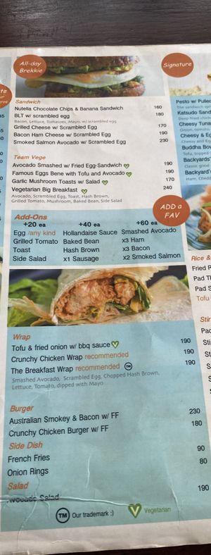 Menu (March 2024). Note: V sign is for vegetarian, vegan is not listed.   at The Backyard Cafe & Bistro in Koh Lanta