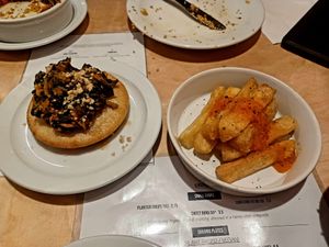 Rice pancake with pumpkin-peanut stew and cassava fries at Chuku's in North London