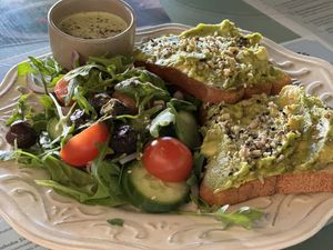Avocado toast on gluten-free bread with salad  at Grandma's in Townsville
