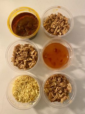 Condiments: sambal, chili sauce, fried onions and seroendeng  at De Vegetarische Toko in The Hague