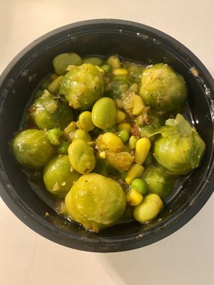 Special dish with brussels sprouts, corn and beans  at De Vegetarische Toko in The Hague